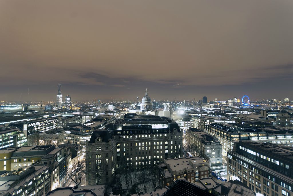 A scattering of snow covers the London rooftops looking over to St Pauls Cathedral from The Barbican. Taken in 2010, it shows The Shard before completion.